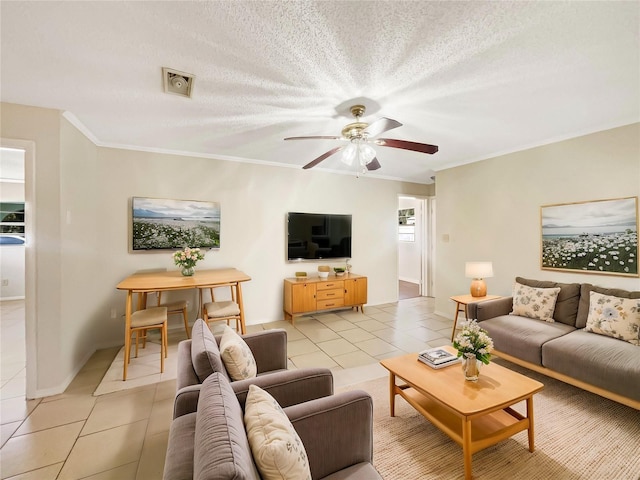 tiled living room with ceiling fan, ornamental molding, and a textured ceiling