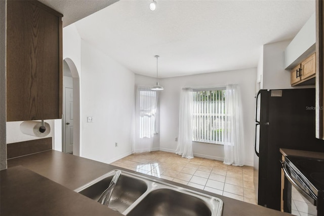 1821 Christina Lee Ln, Saint Cloud, FL 34769 - kitchen with range with electric cooktop, hanging light fixtures, and light tile patterned floors