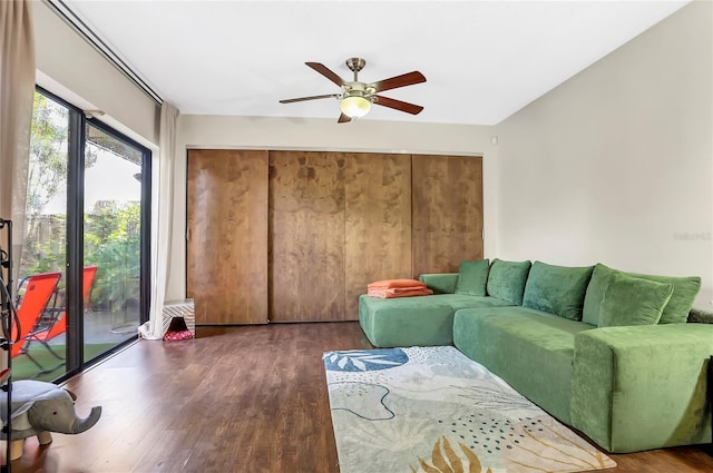 living room with ceiling fan and dark hardwood / wood-style flooring