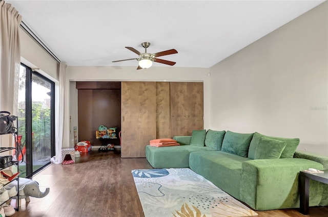 living room featuring dark hardwood / wood-style floors and ceiling fan