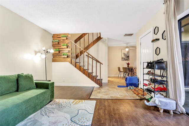 interior space featuring wood-type flooring and ceiling fan