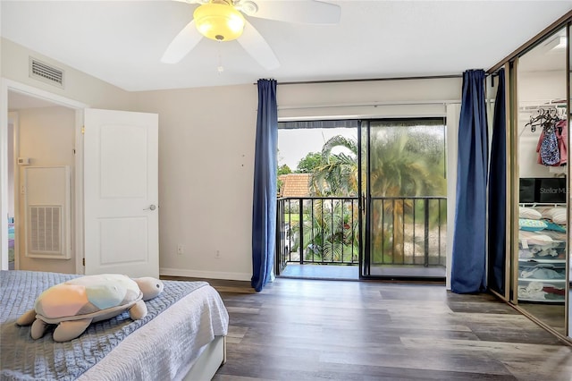 bedroom with a closet, access to outside, dark hardwood / wood-style floors, and ceiling fan