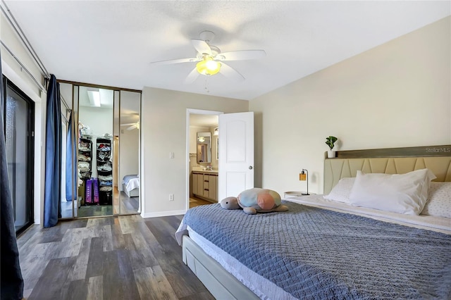 bedroom featuring ceiling fan, ensuite bathroom, dark hardwood / wood-style floors, and a closet