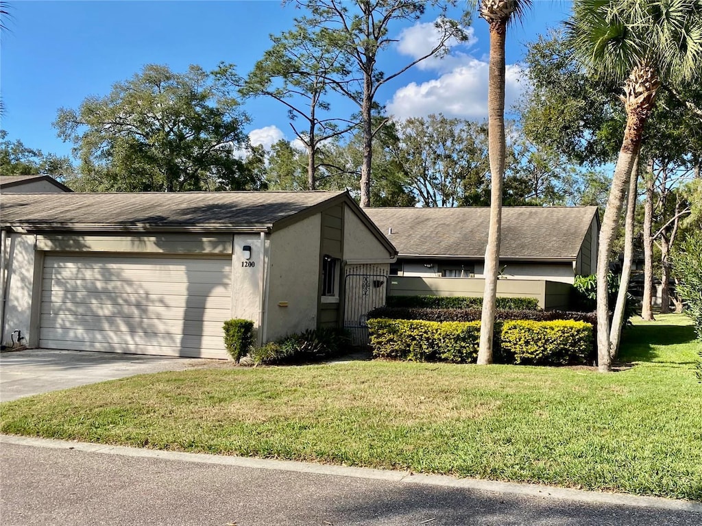 view of home's exterior with a garage and a lawn