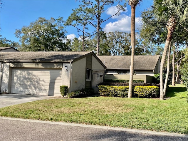 view of home's exterior with a garage and a lawn