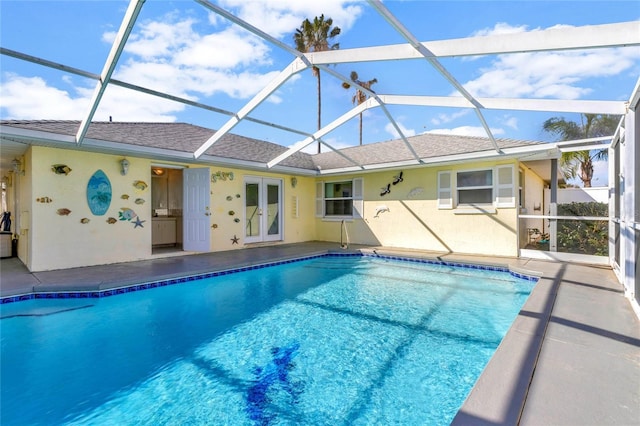 pool featuring french doors, a patio area, and a lanai