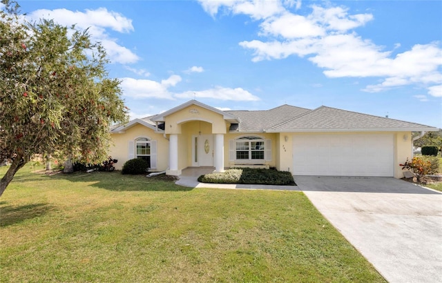 view of front of property with a garage, driveway, a front yard, and stucco siding