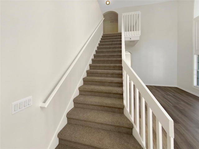 stairs featuring wood-type flooring