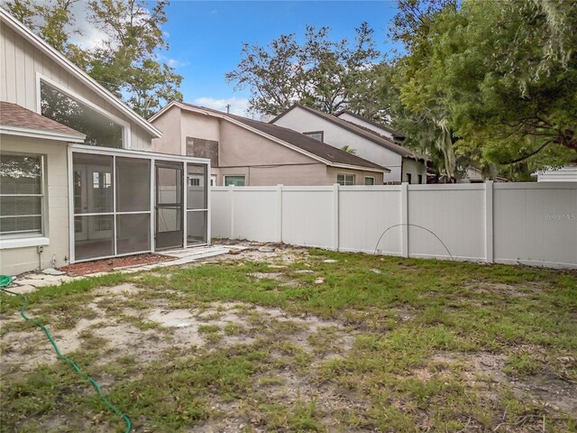 1970 Larkwood Dr, Apopka, FL 32703 - view of yard featuring a sunroom and a fenced backyard