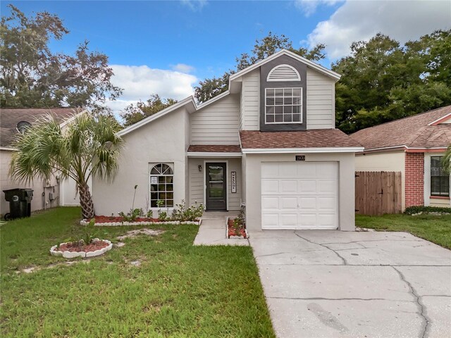1970 Larkwood Dr, Apopka, FL 32703 - traditional home featuring a front lawn, fence, a shingled roof, and concrete driveway