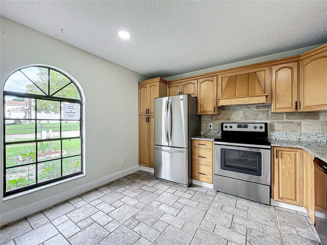 1970 Larkwood Dr, Apopka, FL 32703 - kitchen featuring light stone countertops, a wealth of natural light, tasteful backsplash, appliances with stainless steel finishes, and premium range hood