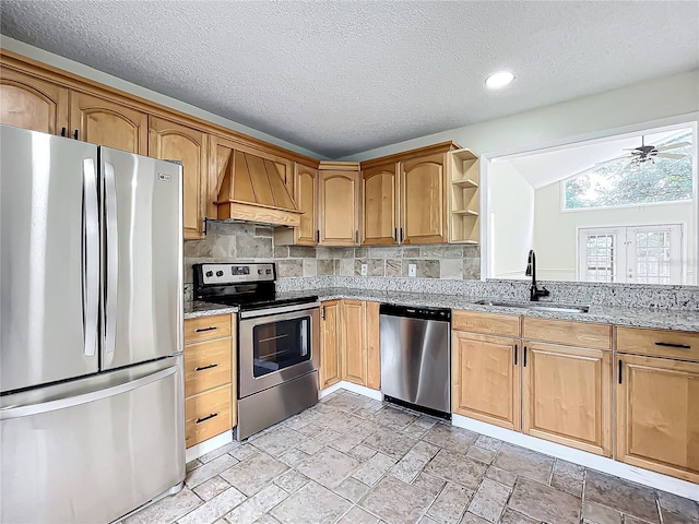 1970 Larkwood Dr, Apopka, FL 32703 - kitchen with light stone countertops, a sink, lofted ceiling, stainless steel appliances, and premium range hood