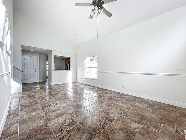 1970 Larkwood Dr, Apopka, FL 32703 - unfurnished living room with high vaulted ceiling, baseboards, and ceiling fan
