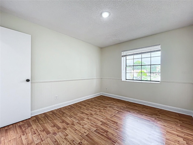 1970 Larkwood Dr, Apopka, FL 32703 - empty room with baseboards, wood finished floors, and a textured ceiling