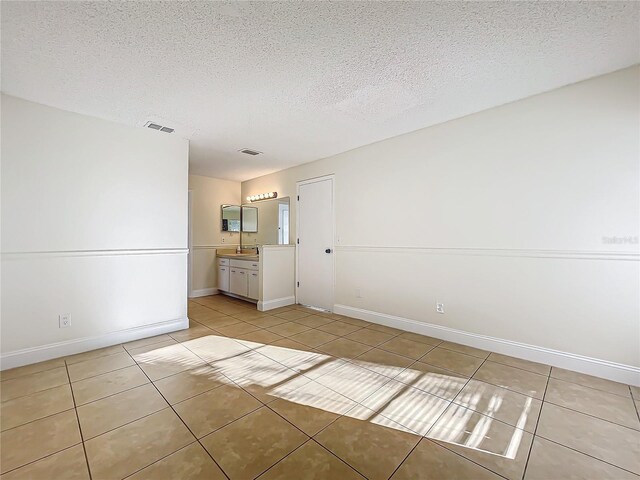 1970 Larkwood Dr, Apopka, FL 32703 - spare room featuring a textured ceiling, light tile patterned flooring, baseboards, and visible vents