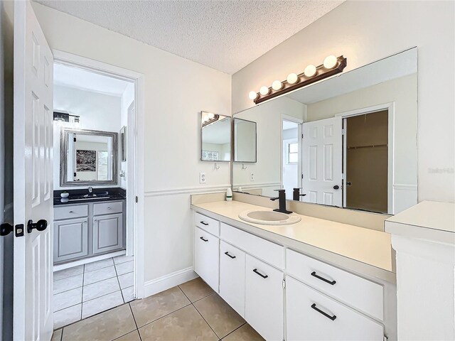 1970 Larkwood Dr, Apopka, FL 32703 - full bath featuring a sink, two vanities, and tile patterned flooring