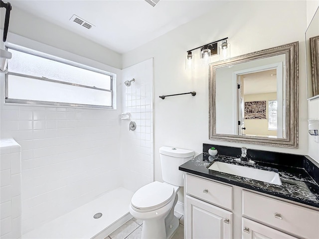 1970 Larkwood Dr, Apopka, FL 32703 - full bathroom featuring toilet, tiled shower, vanity, and visible vents