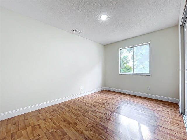 1970 Larkwood Dr, Apopka, FL 32703 - empty room featuring a textured ceiling, light wood finished floors, baseboards, and visible vents