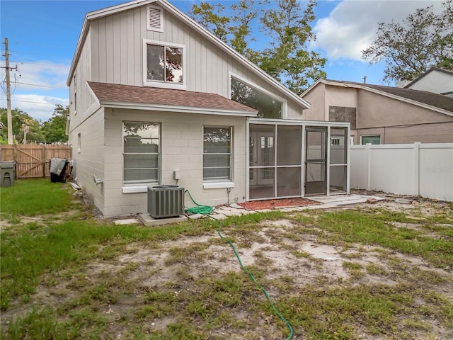 1970 Larkwood Dr, Apopka, FL 32703 - back of house featuring a sunroom, a yard, a fenced backyard, central air condition unit, and roof with shingles