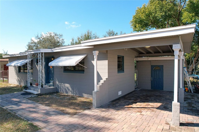 view of front facade with a carport