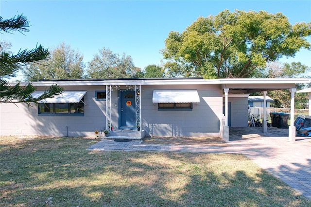 single story home with a front lawn and a carport