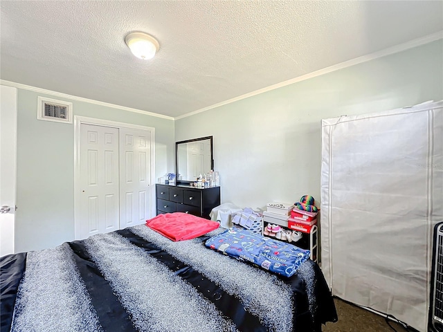 carpeted bedroom with ornamental molding, a textured ceiling, and a closet