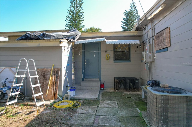 entrance to property featuring central air condition unit