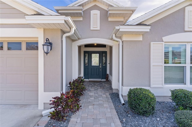 view of exterior entry with a garage