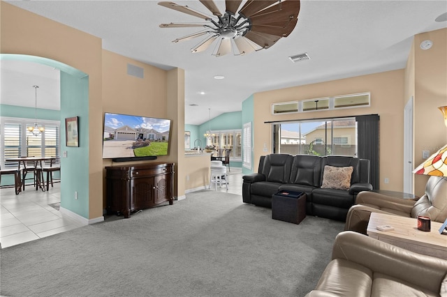 carpeted living room with lofted ceiling and a chandelier