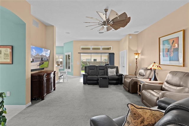 carpeted living room featuring ceiling fan