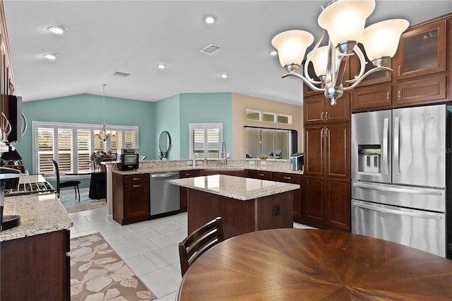 kitchen with a center island, hanging light fixtures, kitchen peninsula, a notable chandelier, and stainless steel appliances