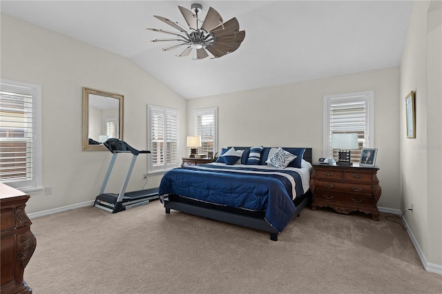 carpeted bedroom with ceiling fan and vaulted ceiling