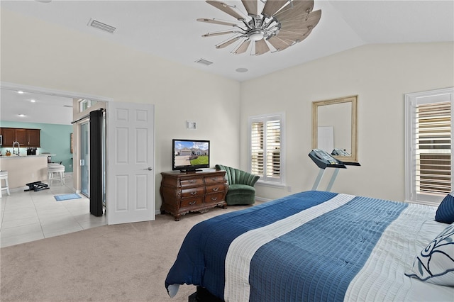 bedroom featuring ceiling fan, light colored carpet, and lofted ceiling