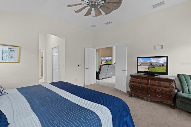 bedroom with vaulted ceiling, light colored carpet, and ceiling fan