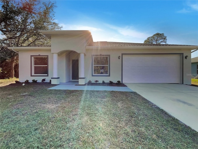 view of front of property with a garage and a front yard