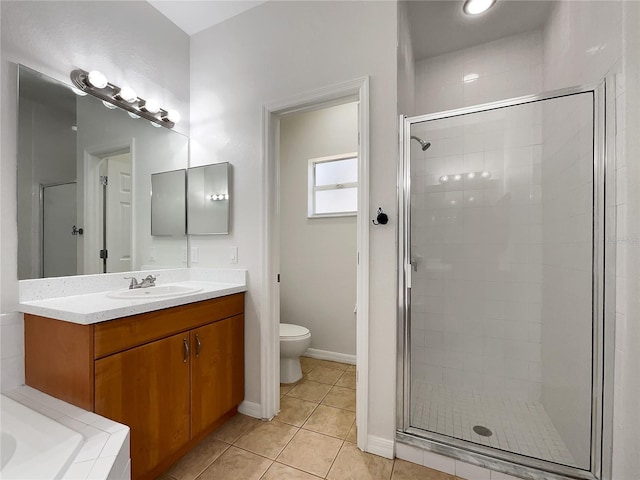 bathroom with vanity, a shower with shower door, tile patterned floors, and toilet