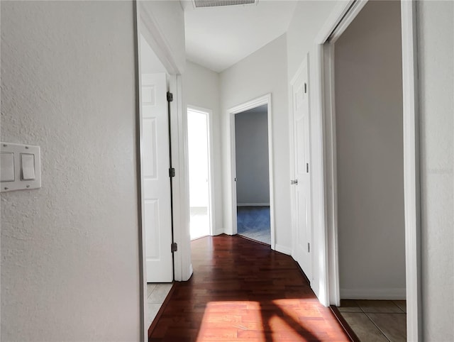 corridor with hardwood / wood-style floors