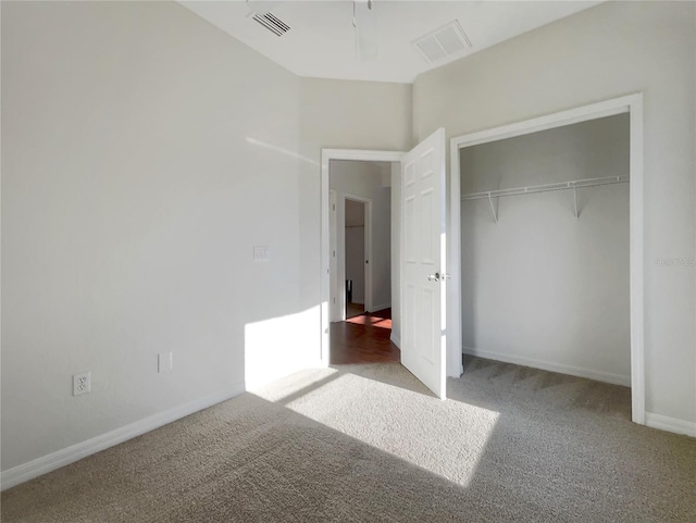 unfurnished bedroom with carpet floors and a closet