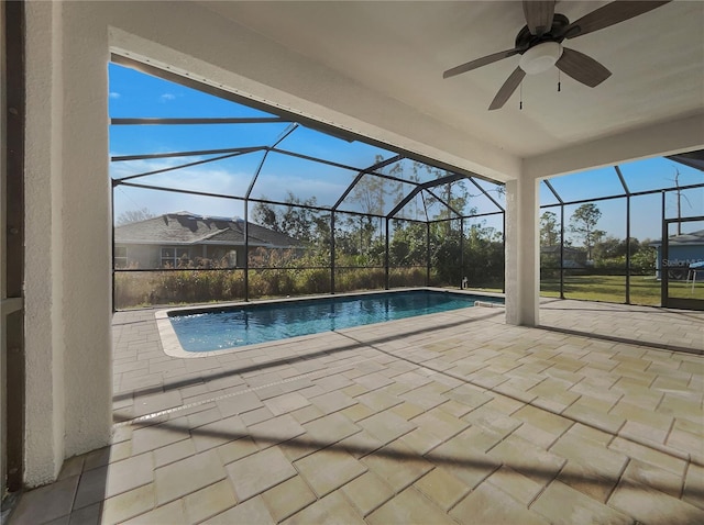 view of pool featuring a patio, ceiling fan, and glass enclosure