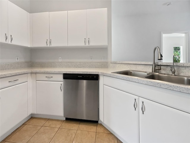 3328 Circleville St, North Port, FL 34286 - kitchen with stainless steel dishwasher, light tile patterned flooring, light countertops, and white cabinetry