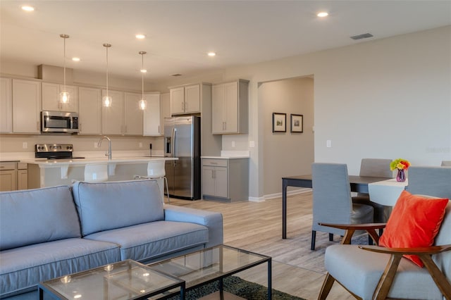 living room with light hardwood / wood-style flooring