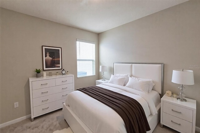 bedroom featuring light carpet