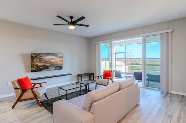 living room featuring light hardwood / wood-style floors and ceiling fan