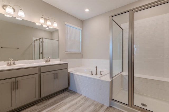 bathroom with vanity, separate shower and tub, and hardwood / wood-style floors