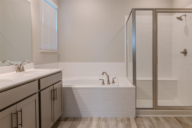 bathroom featuring vanity, shower with separate bathtub, and hardwood / wood-style floors