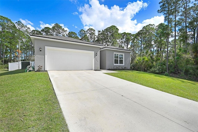 view of front of house with a garage and a front lawn