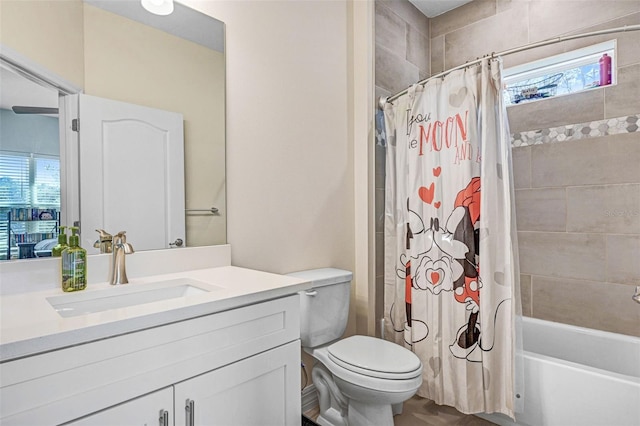 full bathroom featuring vanity, shower / bathtub combination with curtain, and toilet