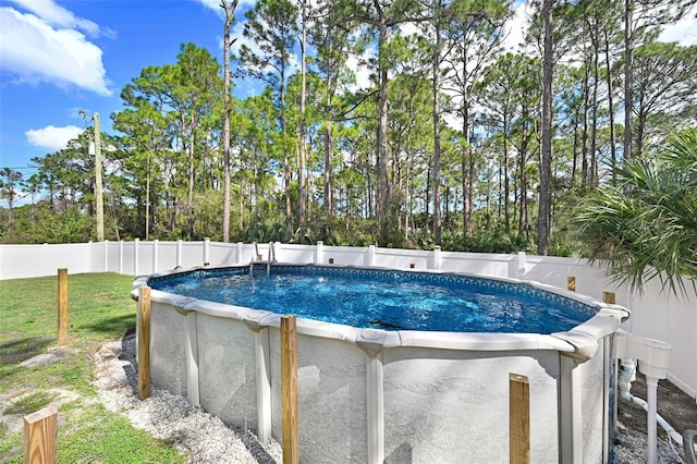 view of pool with a lawn