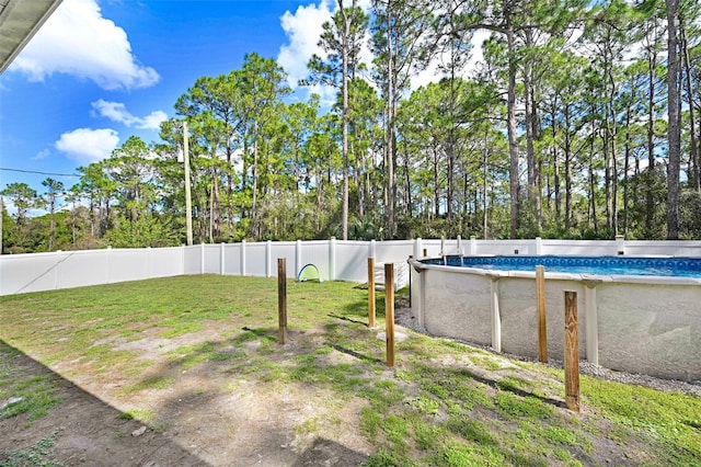 view of yard featuring a fenced in pool