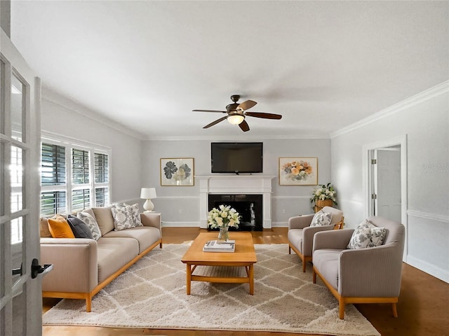 living room featuring crown molding, hardwood / wood-style floors, and ceiling fan